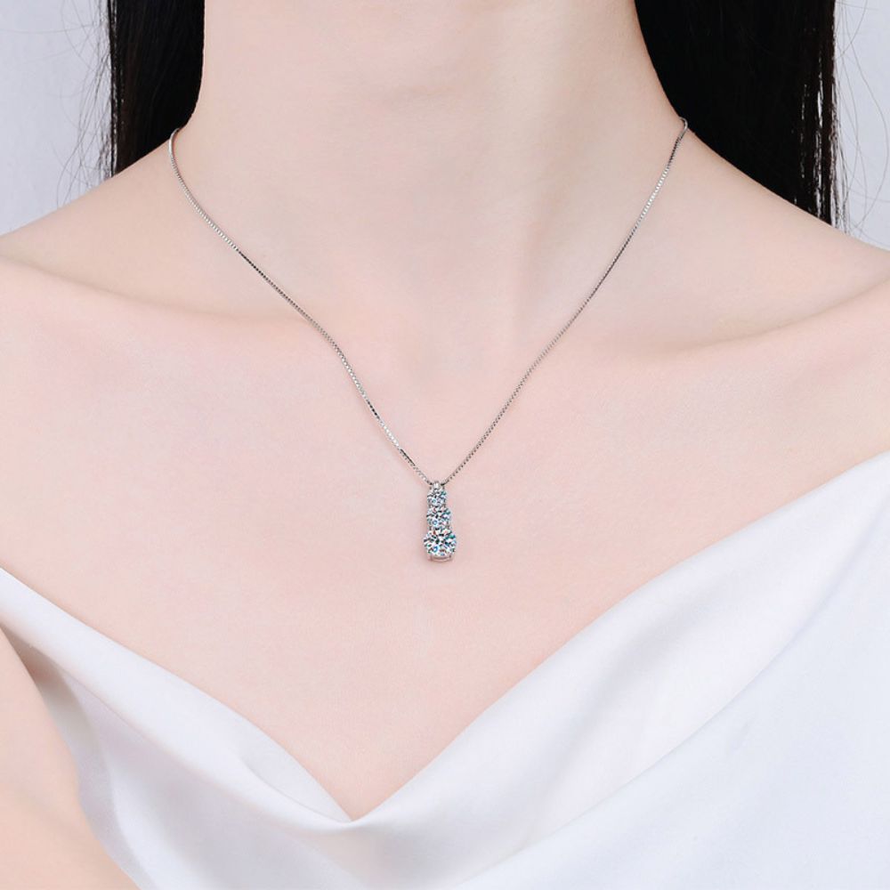 Photo of a woman wearing silver moissanite necklace
