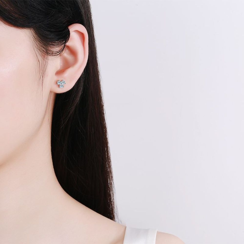 Image of a woman wearing 3-leaf clover stud earrings in silver