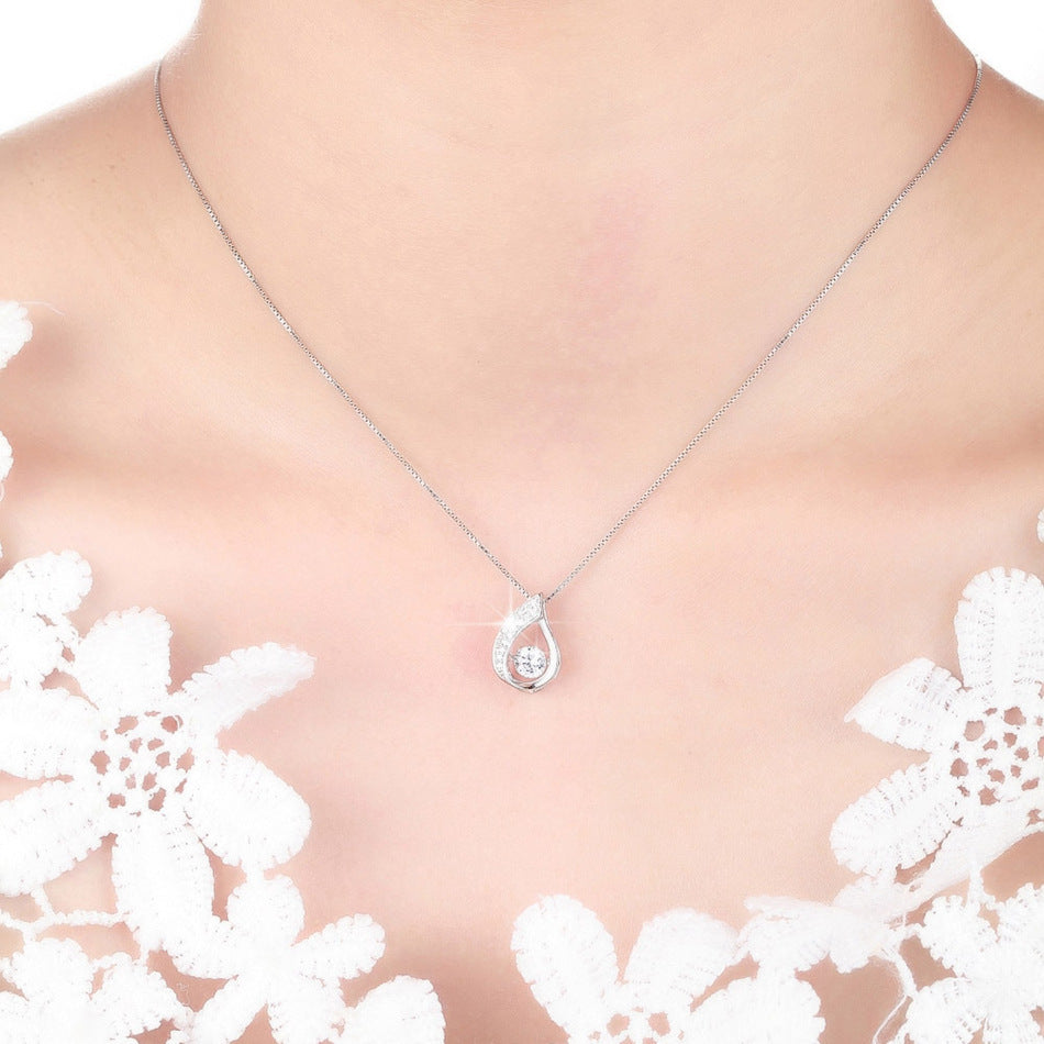 Photo of a woman wearing silver hanging necklace with diamond