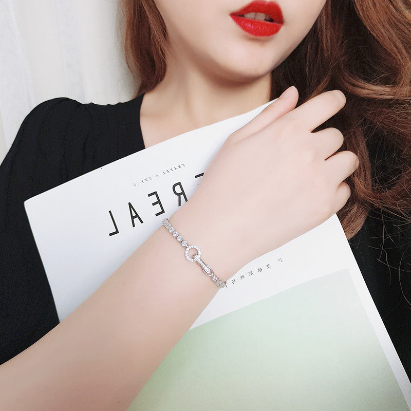 Image of a woman wearing silver jewelry bracelet